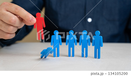 Company director chooses the red figurine of people from the team of employees instead of the blue one. The concept of dismissing a worker and reducing staff. HR processes, recruitment success 134105200