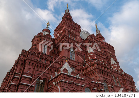 Grand Red Brick Cathedral-Style Building With Tall Towers and Spires Under Blue Sky 134107271