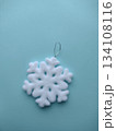 Snowflake Christmas tree toy on a blue background. 134108116