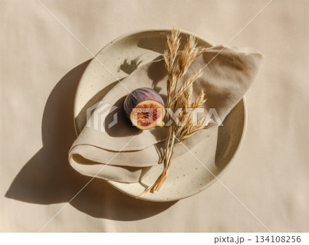 Ceramic plate with linen napkin and dried grass Ceramic plate with linen napkin and dried grass 134108256