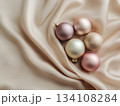 Pastel Christmas baubles on silk fabric 134108284