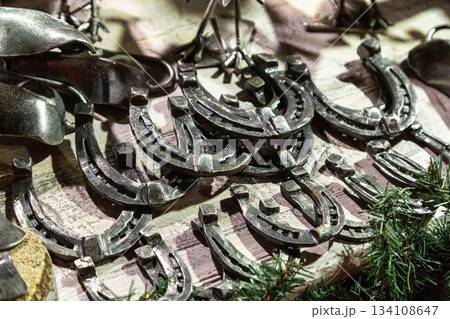 Handmade metal products from a blacksmith are on display at the New Year fair on Red Square near GUM. Horseshoes 134108647