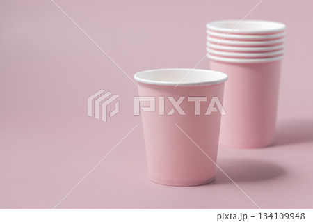 Disposable light pink paper cups closeup, mockup, copy space. No plastic biodegradable single-use 134109948