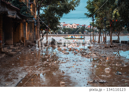 flooded city or town with buildings submerged in overflow water and mud, village underwater after heavy tropical rain and typhoon, consequences with dirt on the street flooded city or town with buildings submerged in overflow water and mud, village underwater after heavy tropical rain and typhoon, consequences with dirt on the street 134110123