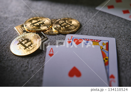 Bitcoin cryptocurrency coins and playing cards on table 134110524