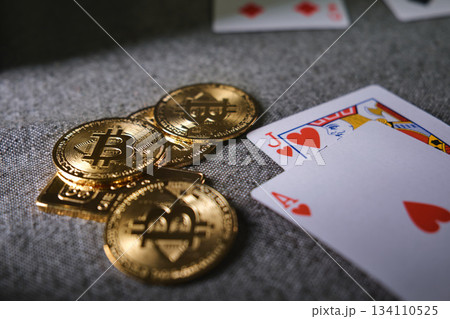 Playing cards and bitcoin cryptocurrency tokens on table Playing cards and bitcoin cryptocurrency tokens on table 134110525