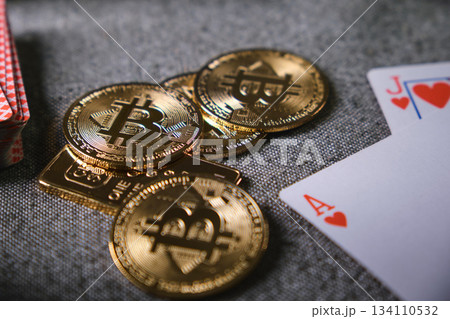 Bitcoin cryptocurrency coins with playing cards showing risk Bitcoin cryptocurrency coins with playing cards showing risk 134110532