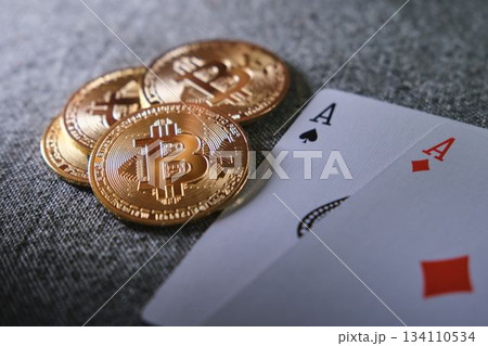 Bitcoin cryptocurrency coins with playing cards on casino table 134110534