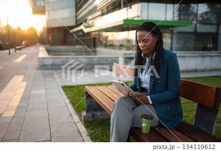 African American businesswoman working with digital tablet outdoor African American businesswoman working with digital tablet outdoor 134110612