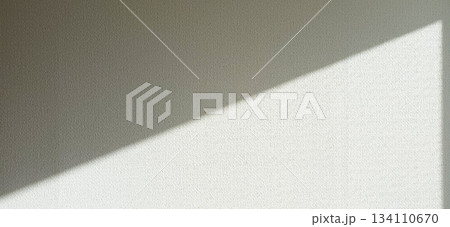 窓から斜めに日光が差し込む部屋の白い壁 134110670