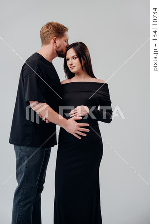 Couple expecting a baby embracing each other warmly 134110734