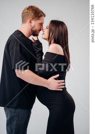 Couple in a tender moment at pregnancy shoot Couple in a tender moment at pregnancy shoot 134110766