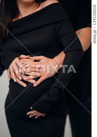 Joyful couple embracing expectant mother during pregnancy Joyful couple embracing expectant mother during pregnancy 134110818