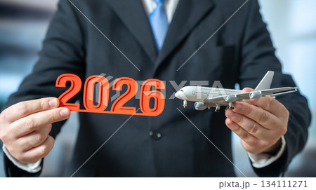 A passenger plane and 2026 in the hands of a businessman. Aviation trends and news. New routes and flight destinations. Airline expansion. Travel forecasts and aviation market insights. 134111271