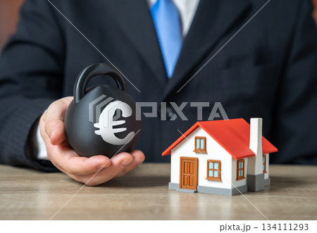 Home mortgage debt. Euro symbol on a weight. Hard-to-afford down payment for a mortgage. Tough loan terms, expensive down payments and unstable market conditions. Home mortgage debt. Home mortgage debt. Euro symbol on a weight. Hard-to-afford down payment for a mortgage. Tough loan terms, expensive down payments and unstable market conditions. Home mortgage debt. 134111293