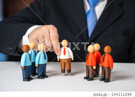 The manager places a mediator between the two teams to resolve the conflict and find a compromise. Concept for workplace mediation, conflict resolution strategy and cooperation between departments. 134111299
