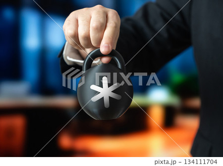 A businessman holds a weight with a star on it. Hidden appendices and clarifications in the contract. Fine print clauses create unexpected obligations. Legal traps and unfair conditions. 134111704