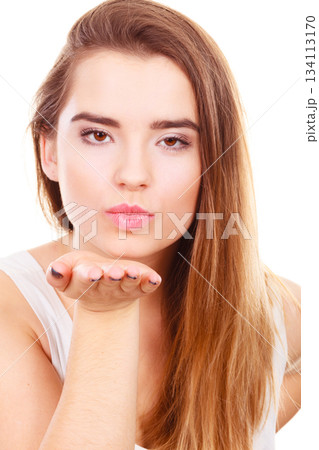 Teenager woman sending air kisses, love gesture 134113170