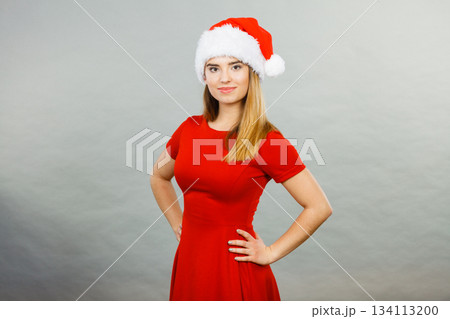 Positive woman wearing Santa Claus helper costume 134113200
