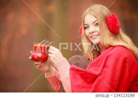 Girl with cup in park. 134113299