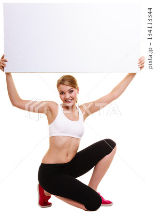 Fitness sporty woman holding blank empty ad banner 134113344