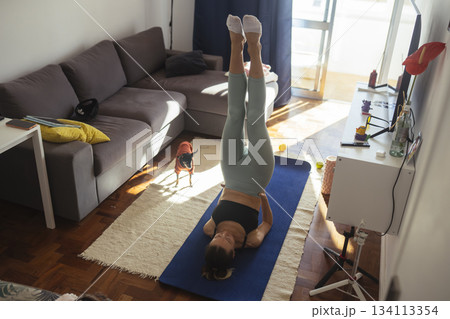 caucasian woman performing legs up inversion for core work caucasian woman performing legs up inversion for core work 134113354