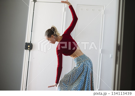 Studio session with female dancer engaging in flexibility exercise 134113439