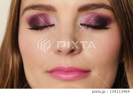 Woman closed eyes with violet dark shadows makeup 134113464