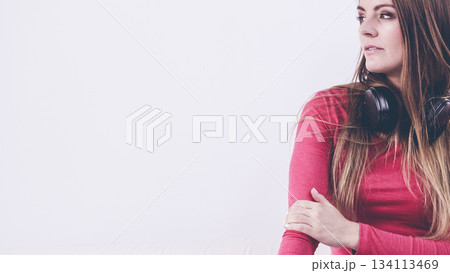 Young lady wearing headphones. 134113469