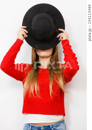 Young lady hiding her face. 134113484