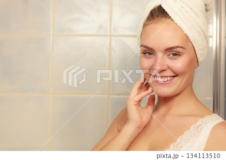 woman in towel on her head in bathroom 134113510