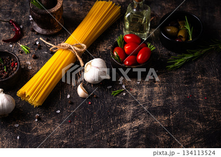 Italian food background with spaghetti, tomato and spices 134113524