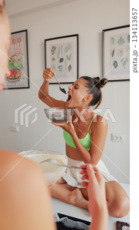 Joyful Moments A Delightful Woman Happily Indulging in Delicious Food in a Stylish Interior 134113657