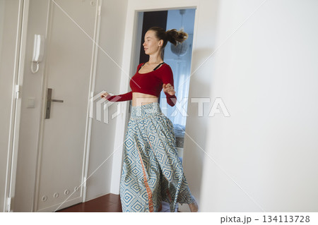 Lively woman performing vibrant spinning dance in sunlight 134113728