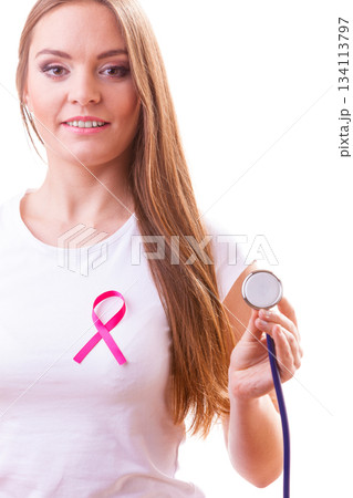 Woman with pink ribbon aids symbol and stethoscope on chest. 134113797