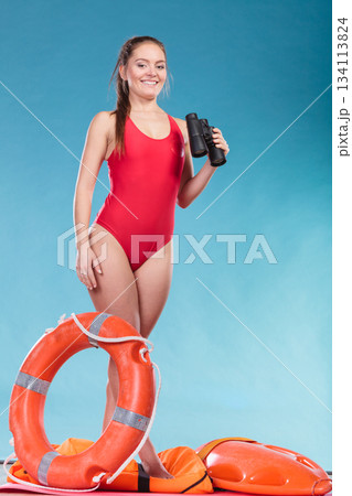 Lifeguard woman on duty with ring buoy lifebuoy. Lifeguard woman on duty with ring buoy lifebuoy. 134113824