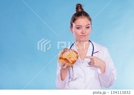 Dietitian with sweet roll bun. Unhealthy junk food 134113832