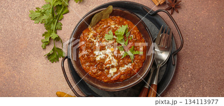 Dal makhani with cream and coriander in bowl is served with spices top view, traditional dish of India 134113977