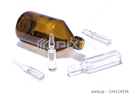 Brown medical vial and ampules on a white 134114256
