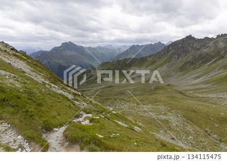 Exploring Smugglerpfad trail in Gargellen, Montafon with mountain views and cloudy skies 134115475