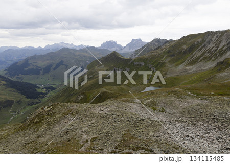 View from Gafier Joch into valley of Sankt Antonien showing lake Gafiersee on Smugglerpfad trail in Switzerland 134115485