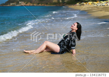 Tourist relaxing on the beach enjoying summer vacation 134116772