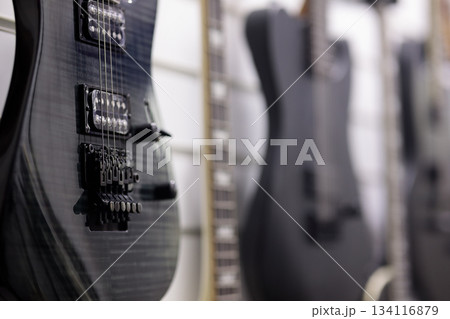 electric guitars hanging on a wall in music store electric guitars hanging on a wall in music store 134116879