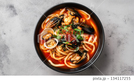 Spicy Korean udon soup with seafood, mussels and clams, gourmet noodle bowl Spicy Korean udon soup with seafood, mussels and clams, gourmet noodle bowl 134117255