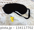 Sleep mask and earplugs on bed close-up, concept of healthy sleep and nighttime relaxation 134117702