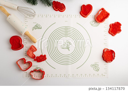 Christmas Holiday Cookie Cutters and Baking Tools on Silicone Mat with Christmas Decor 134117870