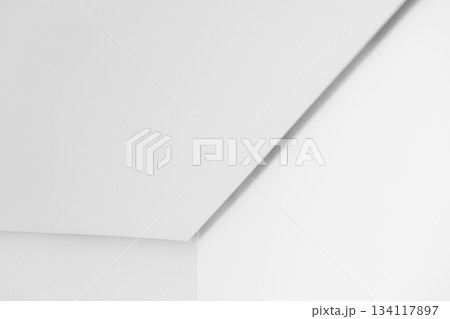 A bright, minimalist white interior featuring clean planes and a diagonal corner A bright, minimalist white interior featuring clean planes and a diagonal corner 134117897
