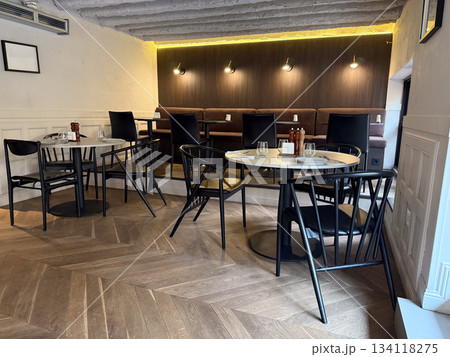 Modern cafe interior at lunchtime. Quiet seating, restaurant ambiance, urban lifestyle and social meeting place atmosphere Modern cafe interior at lunchtime. Quiet seating, restaurant ambiance, urban lifestyle and social meeting place atmosphere 134118275