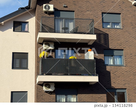 Modern apartment balcony with yellow chrysanthemums and pumpkin decor. Seasonal home aesthetics, autumn decoration, architecture and urban homelife style. Modern apartment balcony with yellow chrysanthemums and pumpkin decor. Seasonal home aesthetics, autumn decoration, architecture and urban homelife style. 134118298