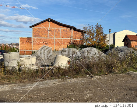 Building and construction materials outdoors. Urban expansion, development and unfinished architectural landscape. Building and construction materials outdoors. Urban expansion, development and unfinished architectural landscape. 134118301
